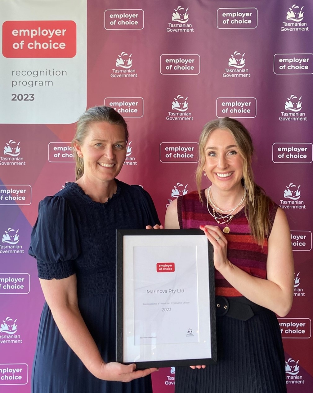 Amanda Mackinnon and Ellie Paine holding a Employer of Choice Certificate