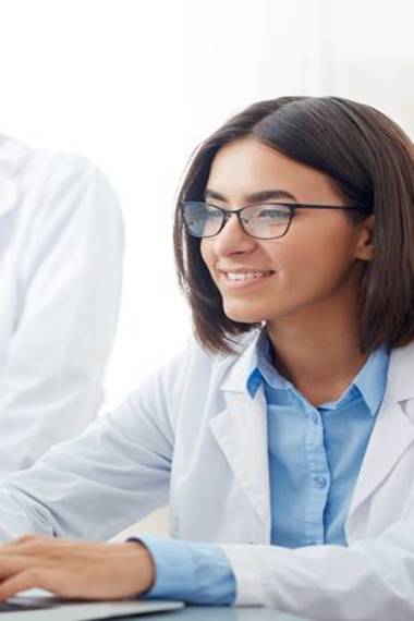 Female scientist working at laptop in laboratory