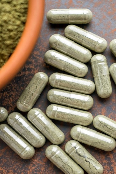 Green capsules on table