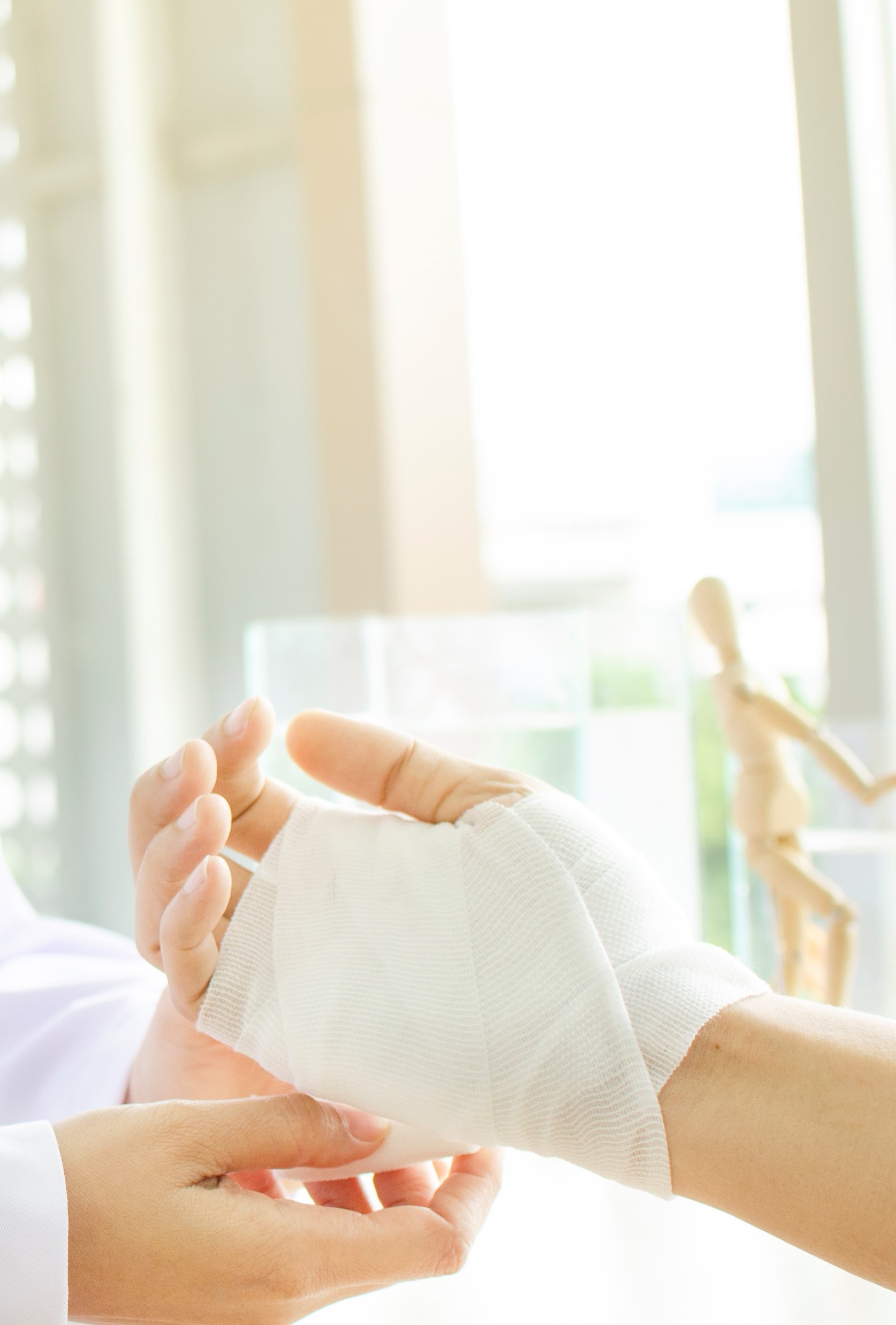 Close up of a patient having a hand wound dressed.