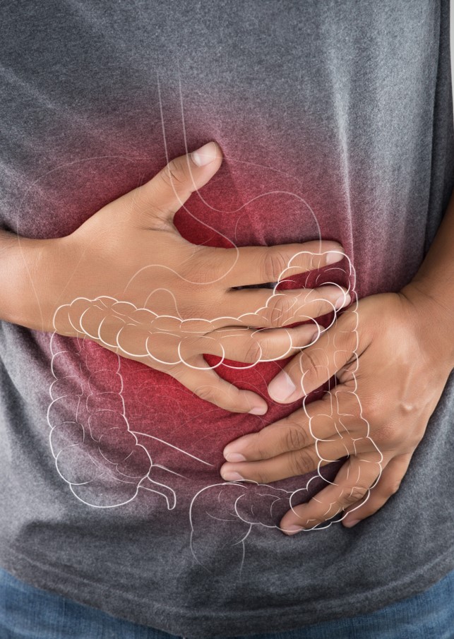 Man bent over and clutching lower abdomen