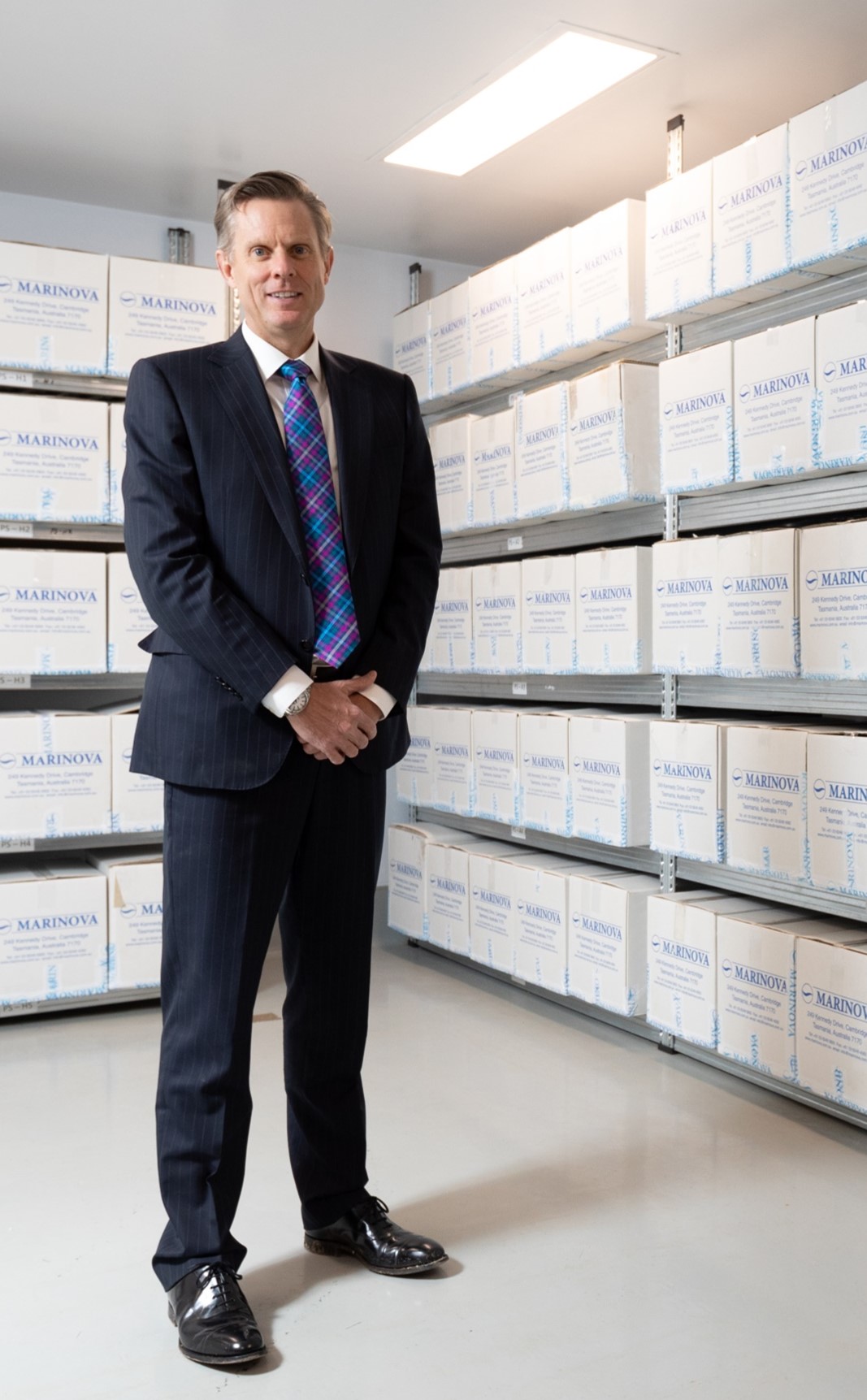 CEO Paul Garrott standing with Marinova boxes