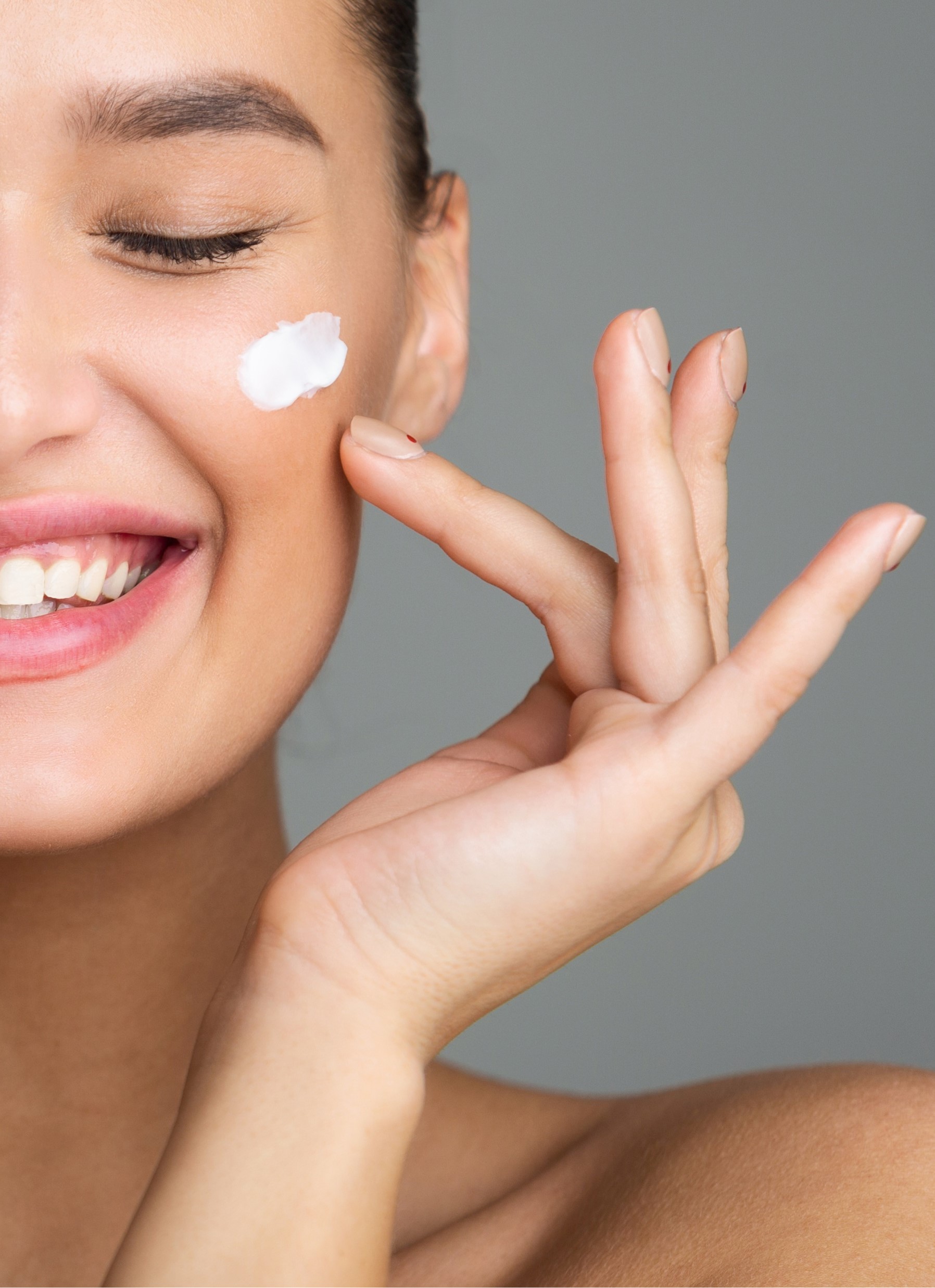 Women putting cream on face with outstretched hands