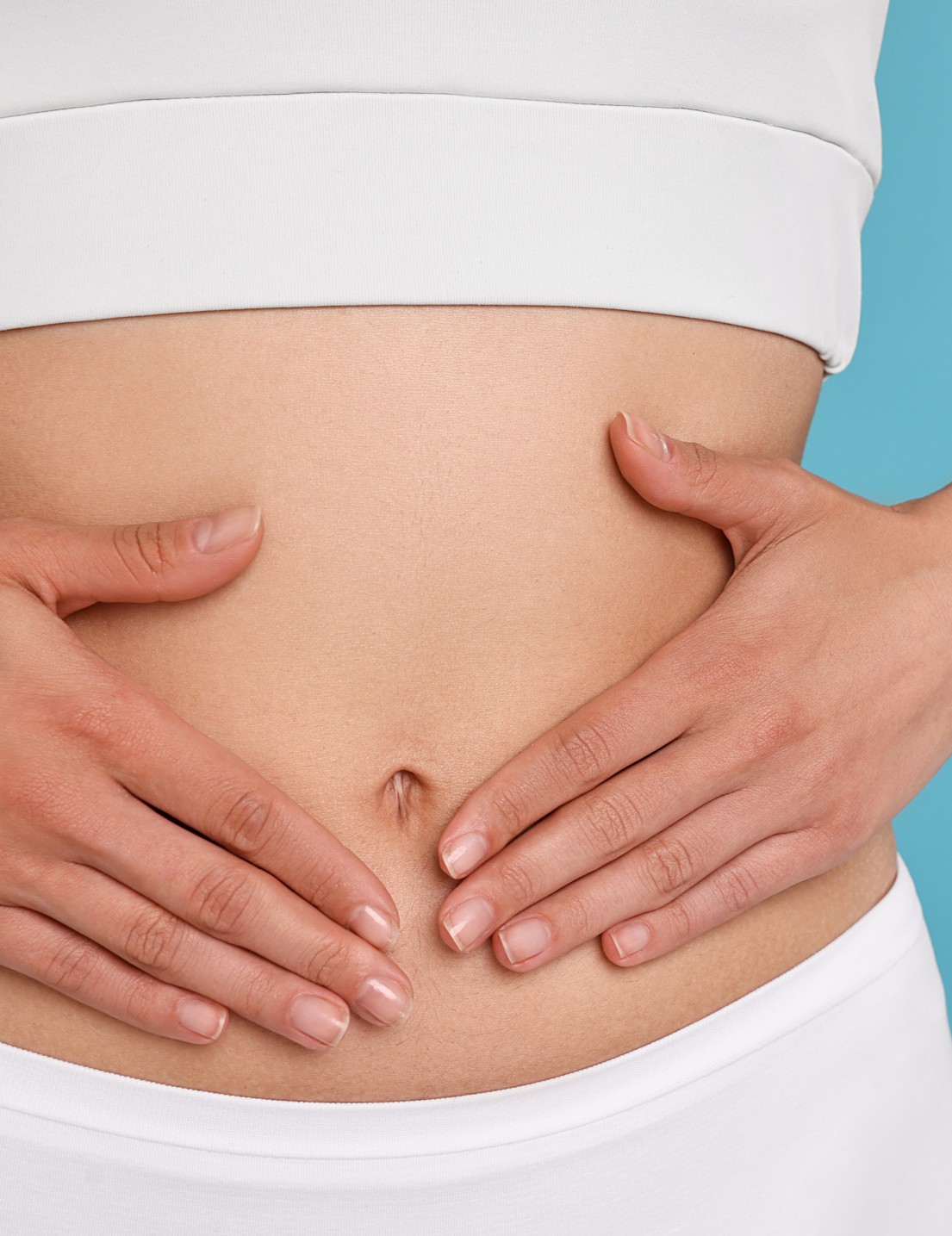 Womans hands resting on her stomach